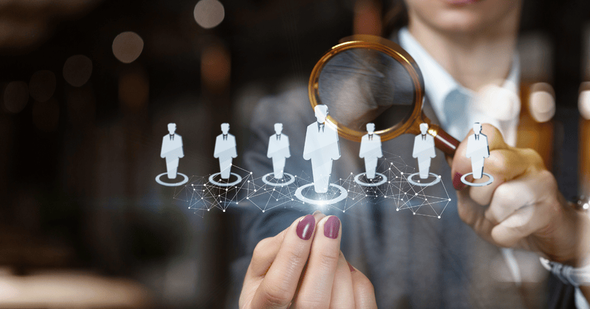 Person using a magnifying glass to research and select a realtor in Jackson Missouri, with digital icons representing different real estate agents.